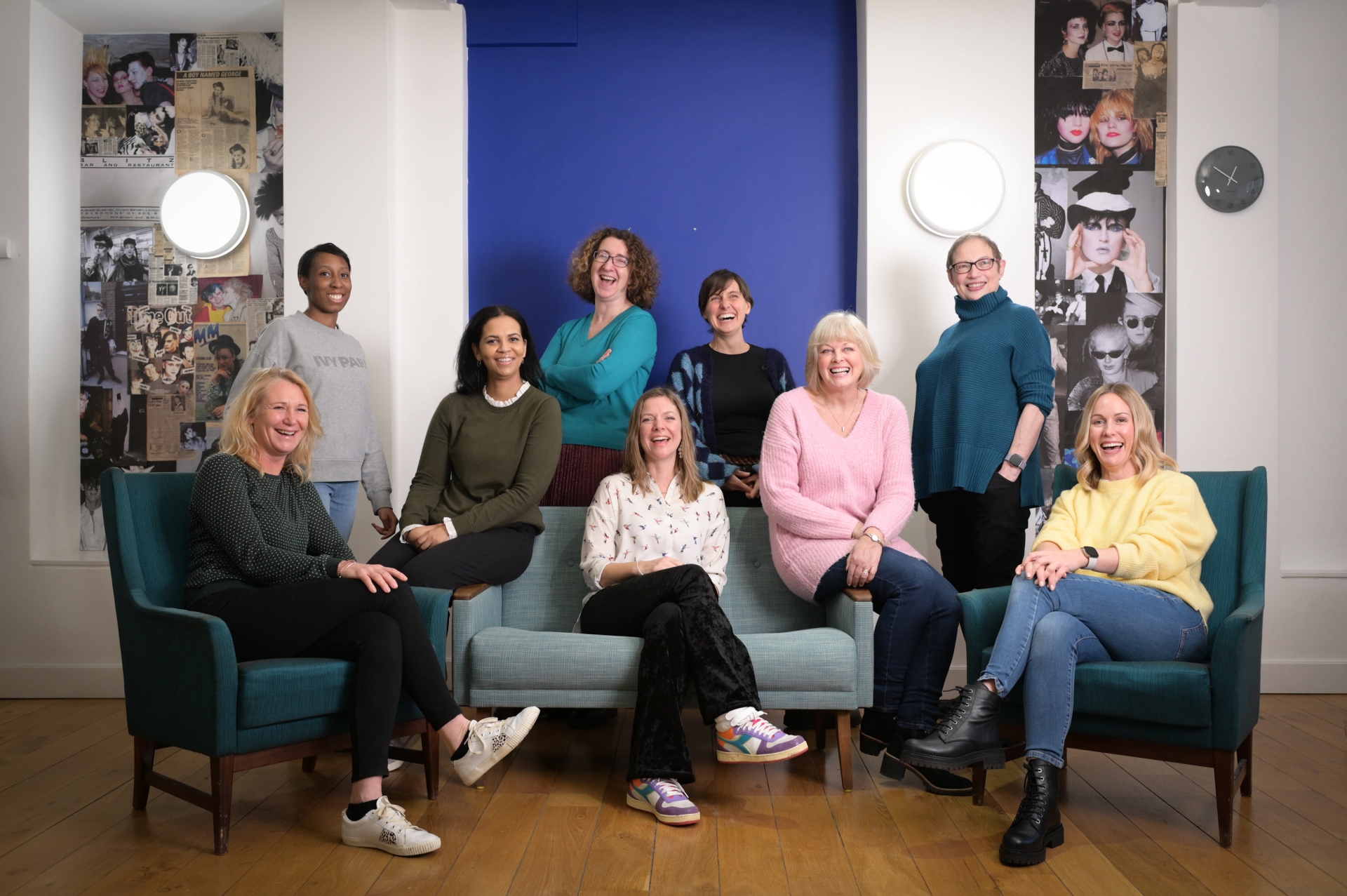 The Thresholds Team sat together on a sofa smiling