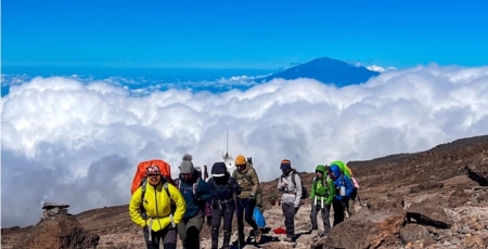 6 black women on a mountain above the cloud line