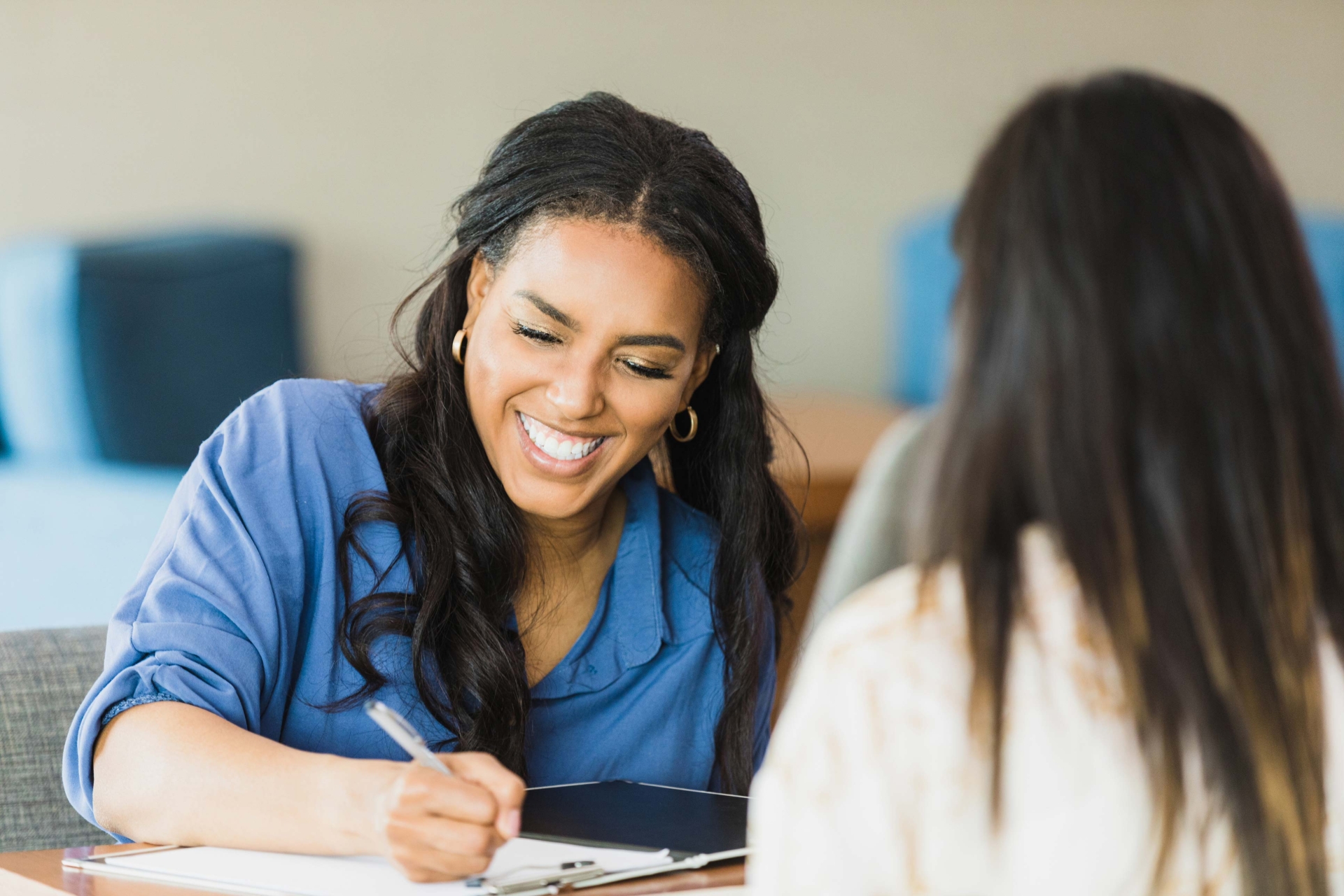 Woman smiling whilst conducting an interview